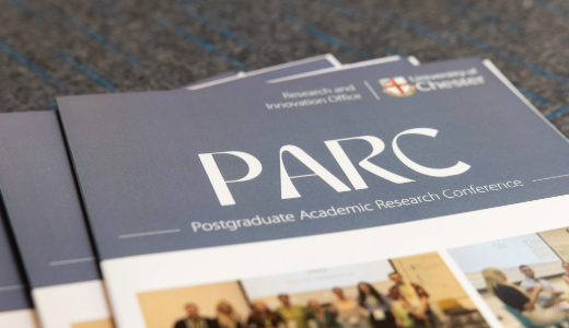 Close-up of a brochure titled “PARC – Postgraduate Academic Research Conference”.
