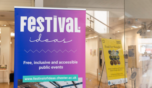 Colourful “Festival of Ideas” banner promoting free, inclusive public events, displayed inside a modern building.