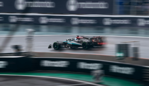 Formula One car speeding around a race circuit, captured with motion blur to emphasise speed.
