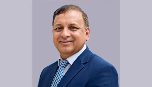Portrait of a University academic in a blue suit and patterned tie.