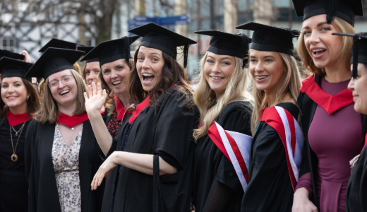Graduates posing for a group photograph after their graduation ceremony.